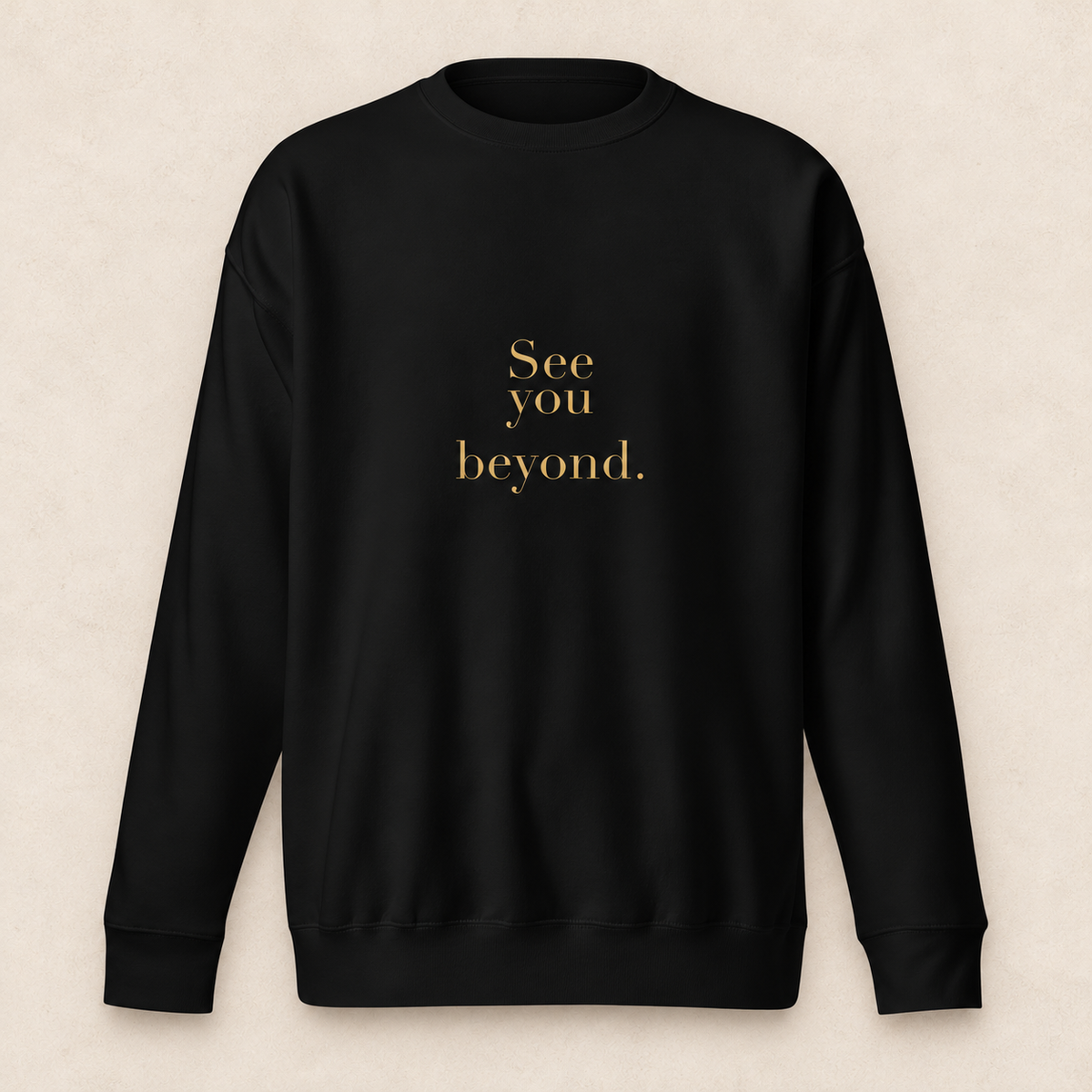 beyond crewneck in black with original SYB gold artwork on a pale limestone studio background