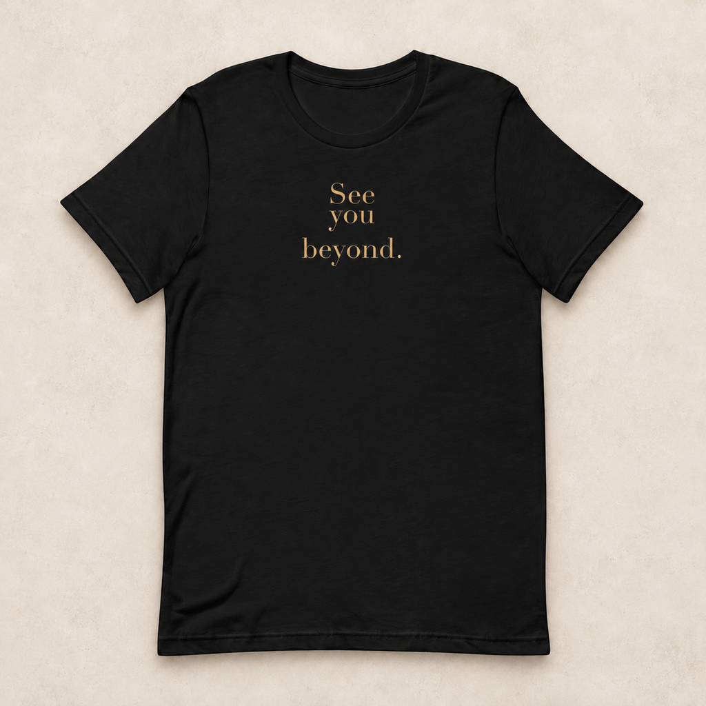 Beyond Tee in black with the gold-tone See you beyond. front print; studio mockup.
