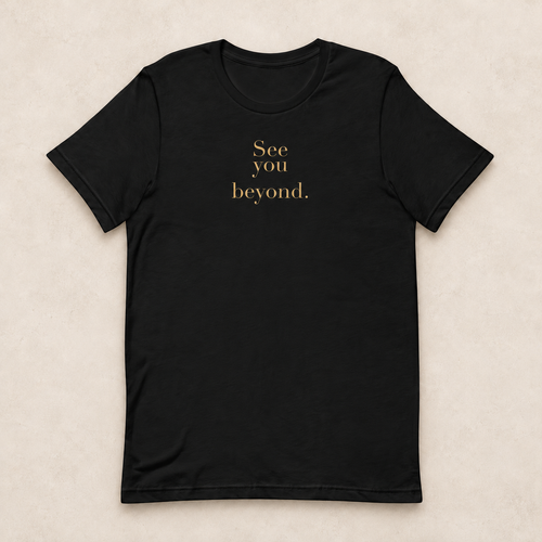 Beyond Tee in black with the gold-tone See you beyond. front print; studio mockup.
