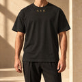 Washed black oversized SYB Wordmark Heavyweight Tee styled in a limestone atelier