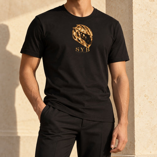 Icon Tee in black, styled with tailored trousers; original gold-tone helmet and SYB front print.