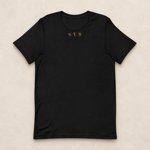 Wordmark Tee in black with a small gold-tone SYB front print; studio mockup.